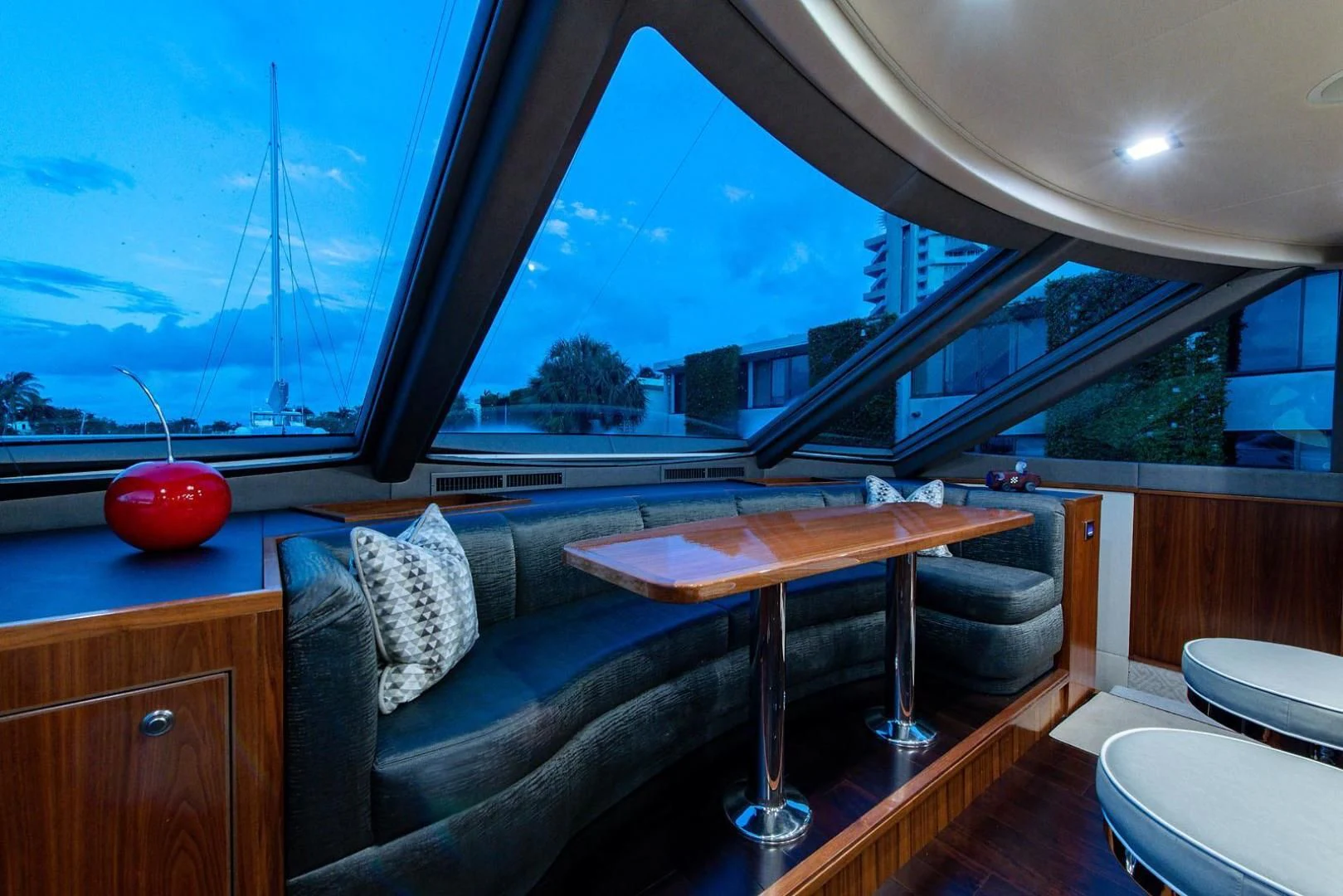a room with a couch and a table and a window aboard OBSESSION Yacht for Sale