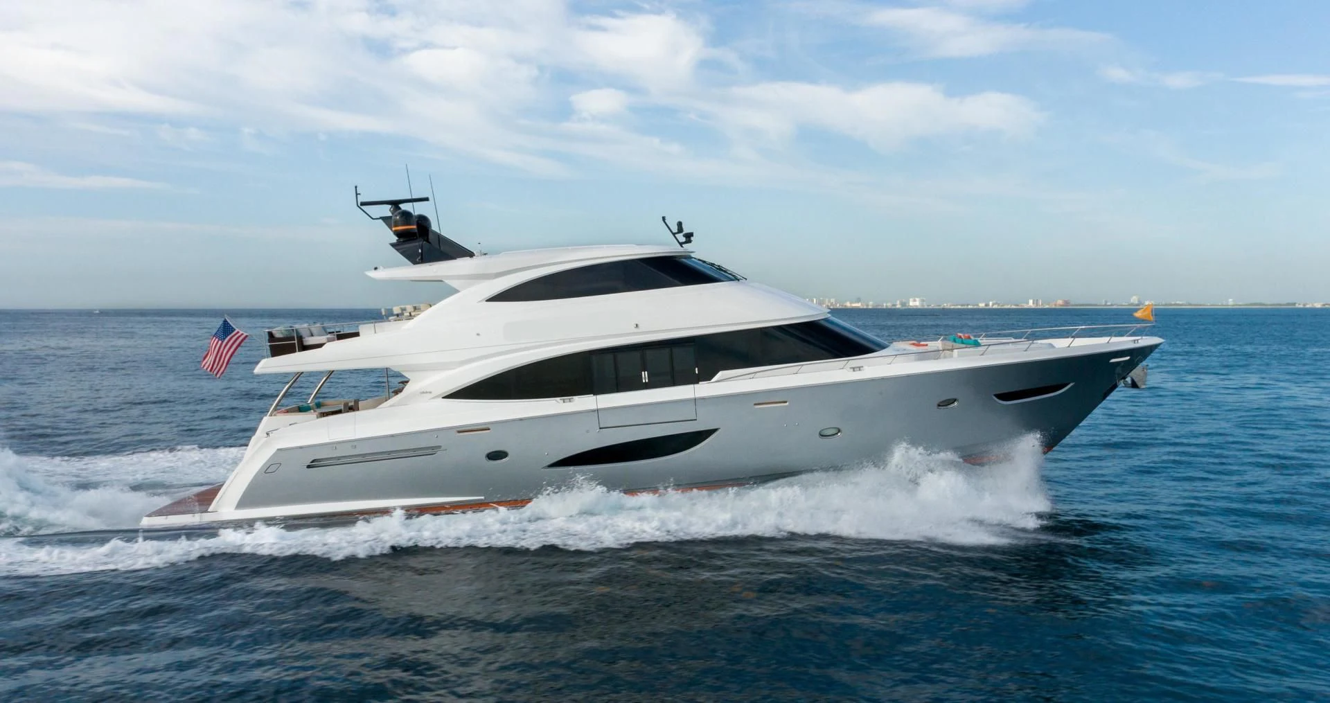 a white yacht on the water aboard OBSESSION Yacht for Sale