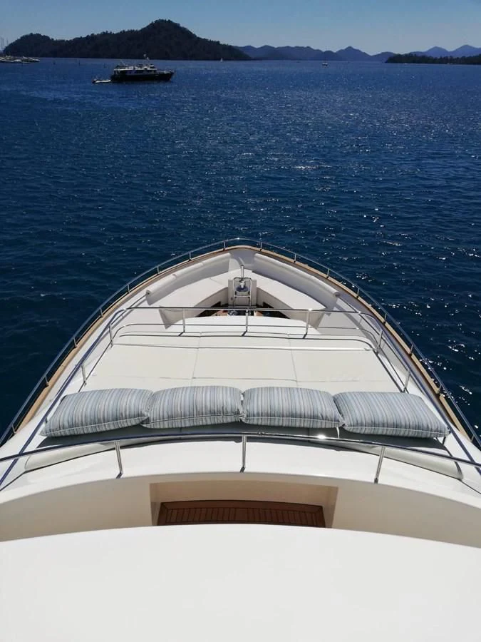 a white building with a balcony over water aboard HAG Yacht for Sale