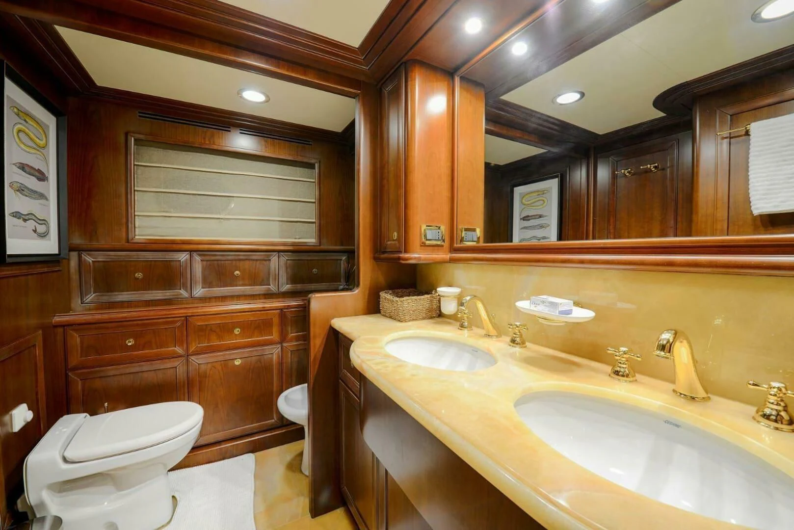 a bathroom with wooden cabinets aboard HAG Yacht for Sale