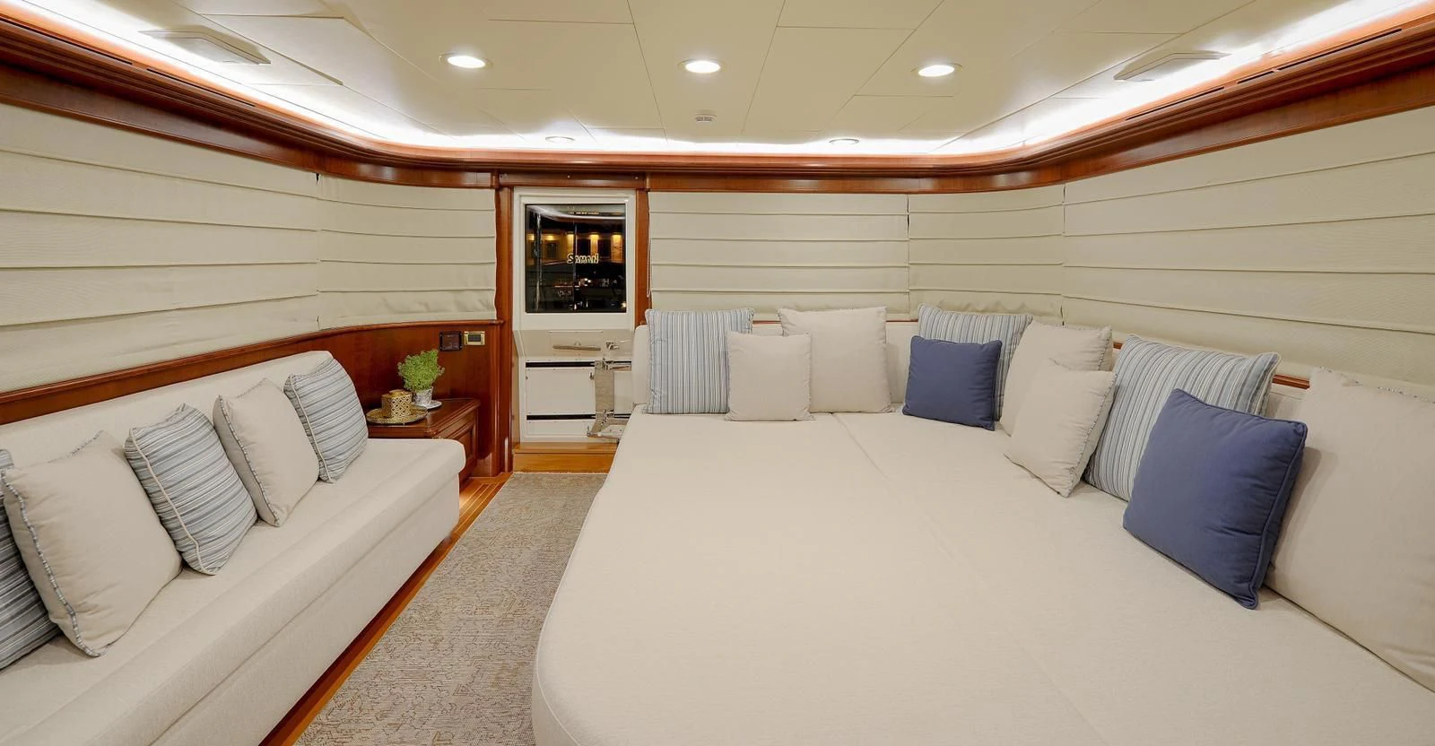 a room with a bed and a mirror aboard HAG Yacht for Sale