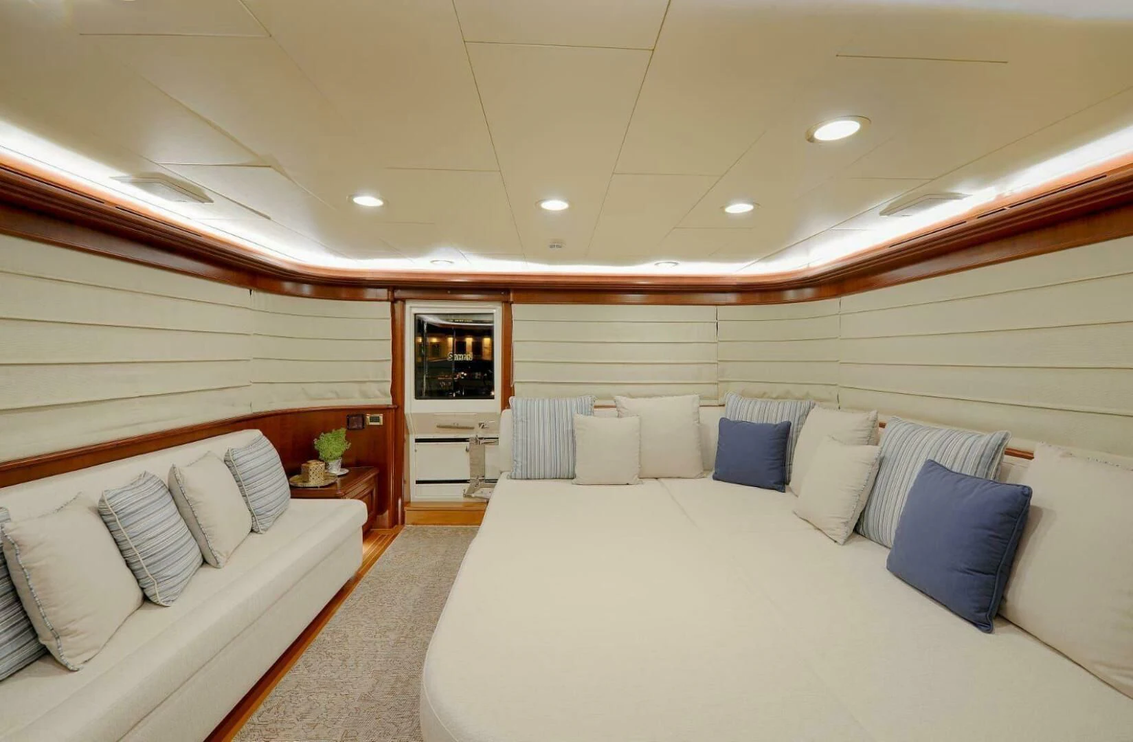 a room with a bed and a couch aboard HAG Yacht for Sale