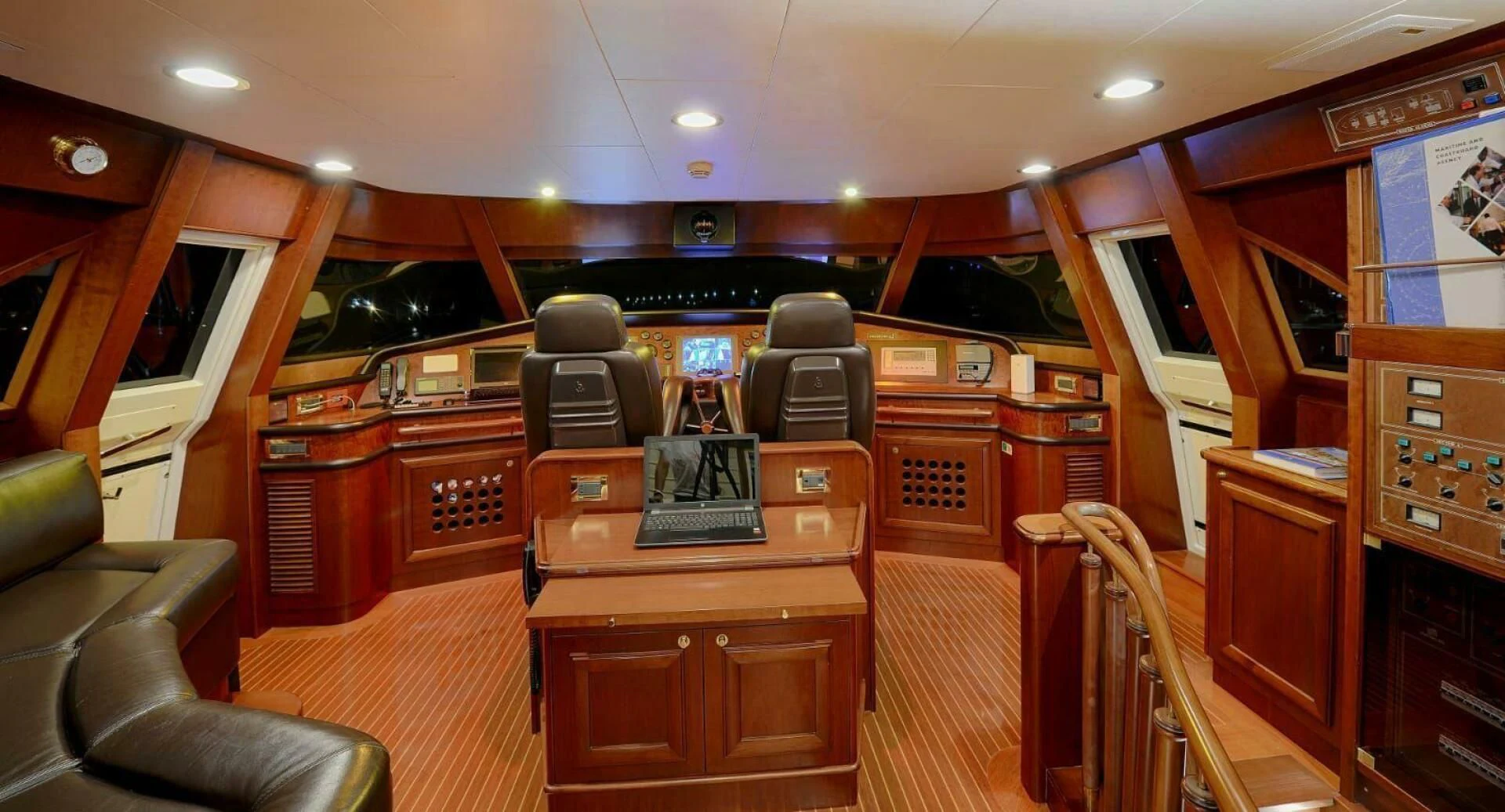 a room with a desk and chairs aboard HAG Yacht for Sale