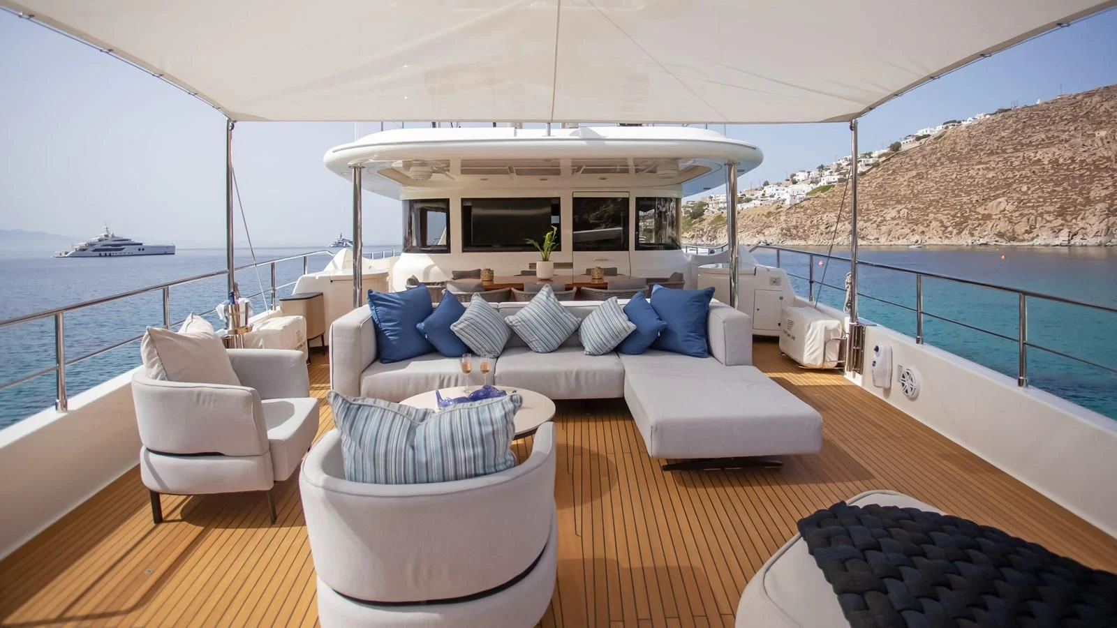 a large white tent with a couch and a table on a deck aboard HAG Yacht for Sale
