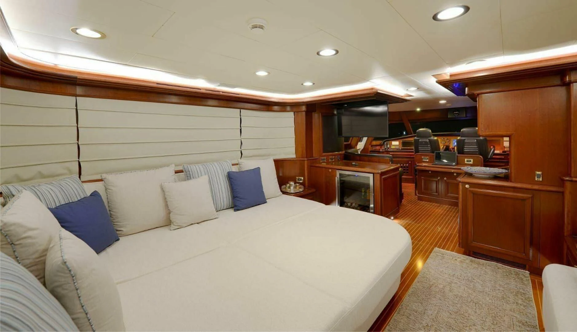 a large bedroom with a large bed aboard HAG Yacht for Sale
