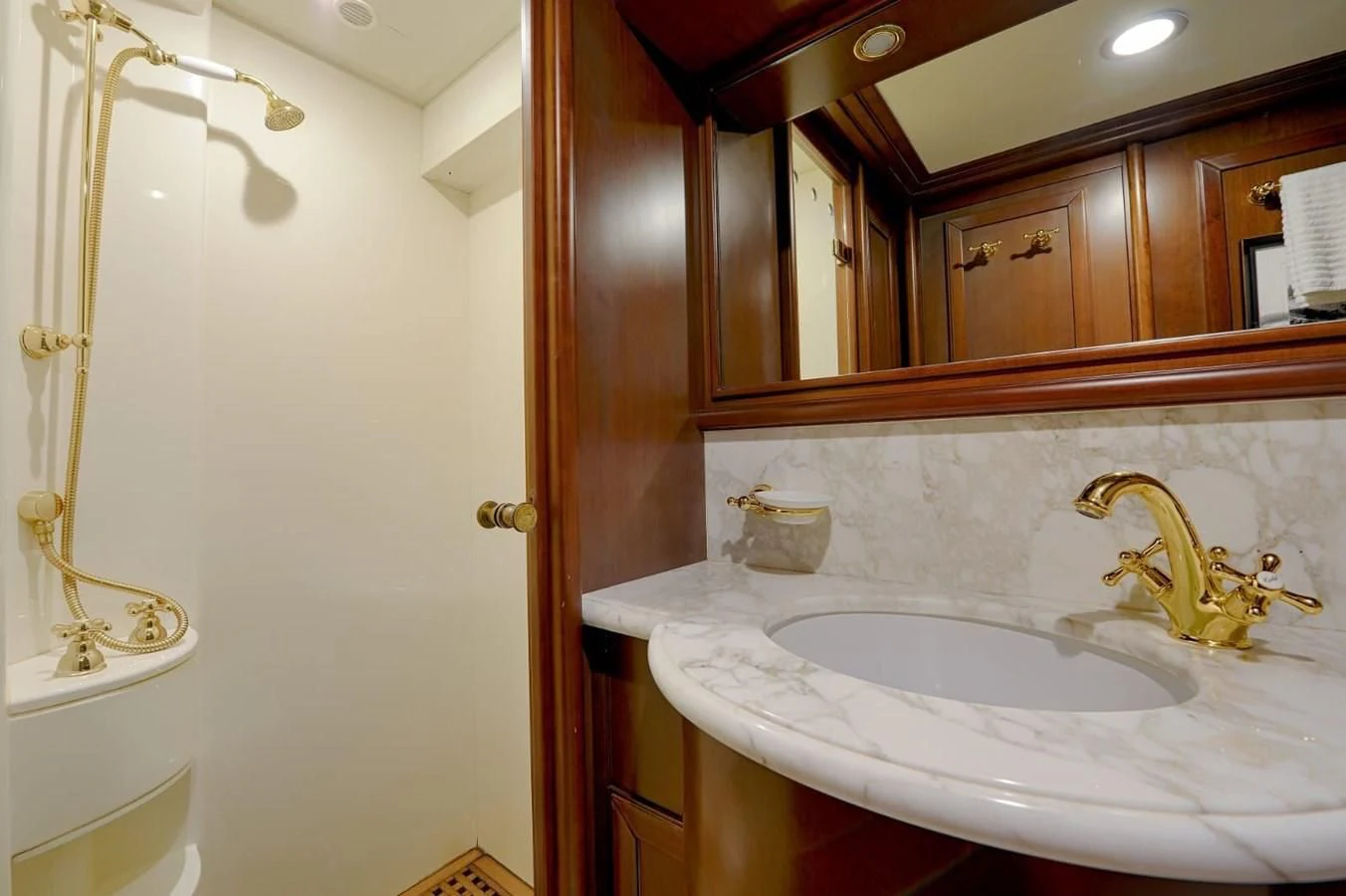a bathroom with a sink and mirror aboard HAG Yacht for Sale
