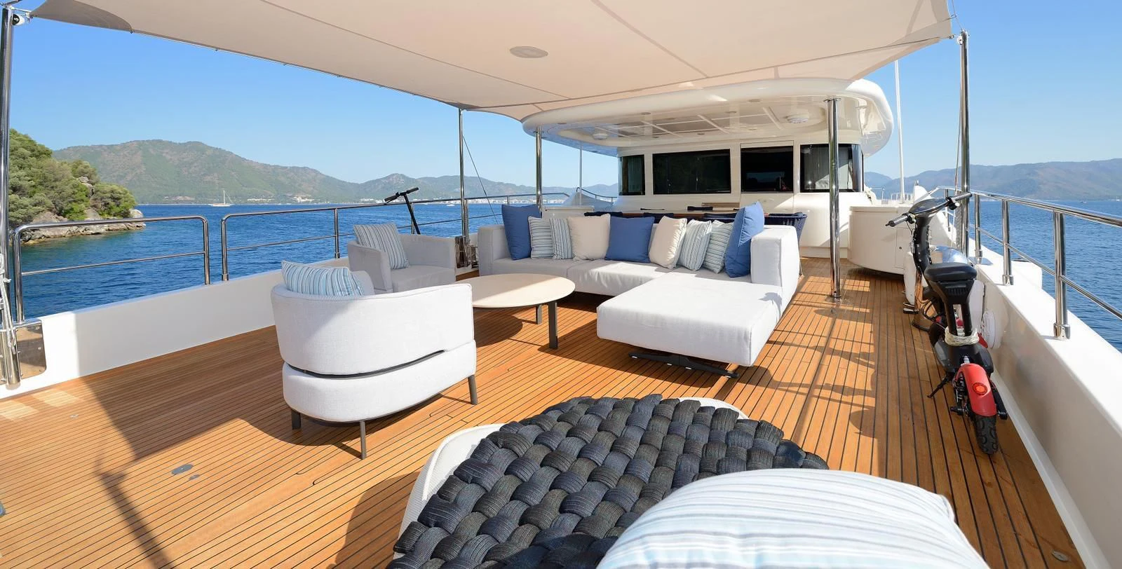 a large white lounge chair on a deck overlooking a large body of water aboard HAG Yacht for Sale