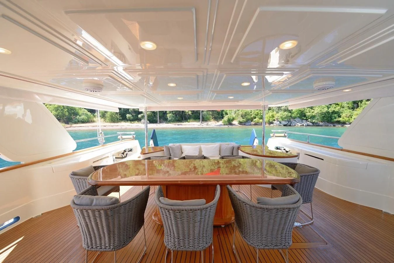 a table and chairs on a deck aboard HAG Yacht for Sale