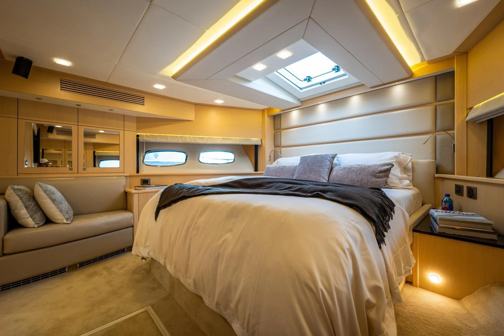 a bedroom with a bed and a couch aboard THE KING Yacht for Sale
