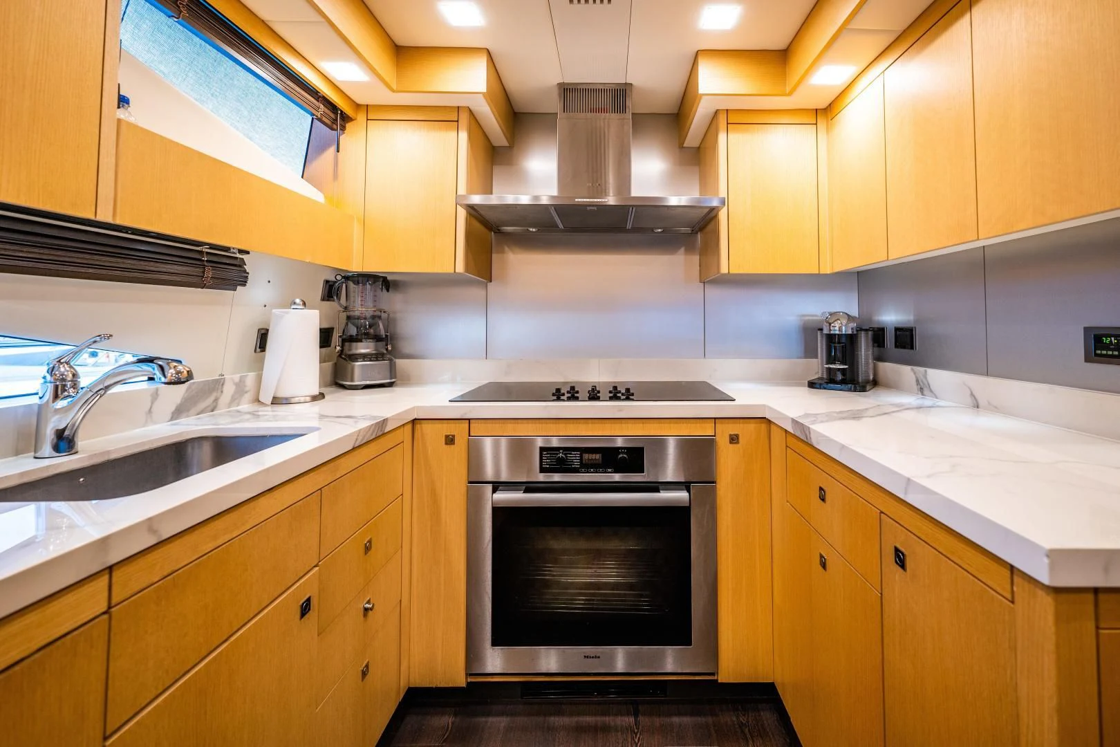 a kitchen with wooden cabinets aboard THE KING Yacht for Sale