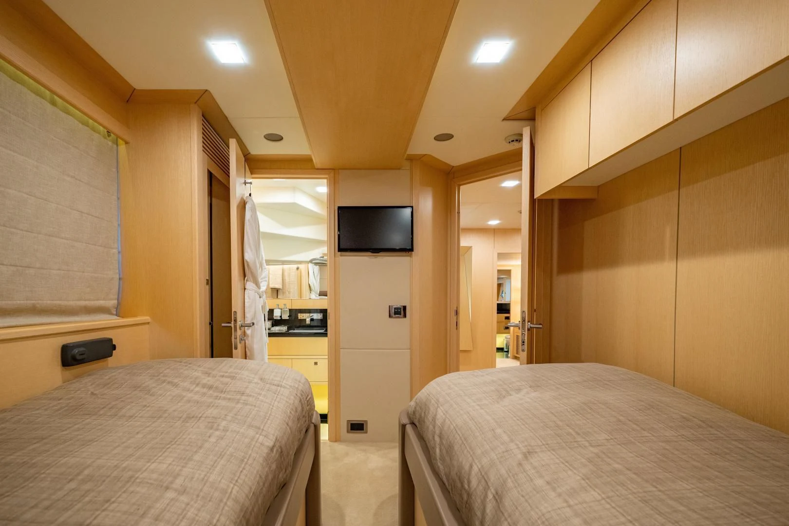 a bedroom with a bed and a television aboard THE KING Yacht for Sale