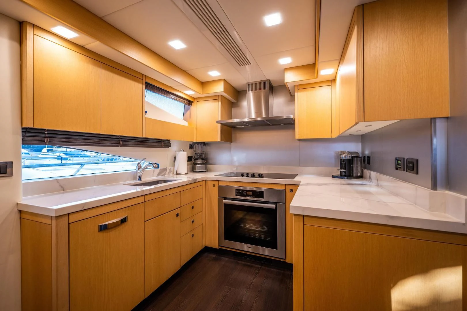a kitchen with wooden cabinets aboard THE KING Yacht for Sale