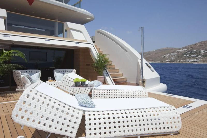 a table with chairs on it next to a large body of water aboard SARAMOUR Yacht for Sale
