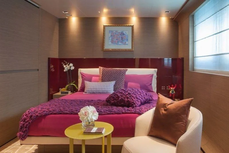 a bed with pink pillows aboard SARAMOUR Yacht for Sale