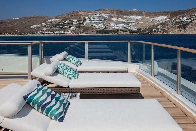 a lounge chair on a balcony overlooking a canyon aboard SARAMOUR Yacht for Sale