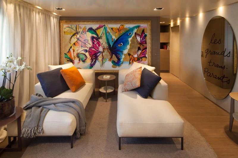 a room with a couch and a painting on the wall aboard SARAMOUR Yacht for Sale