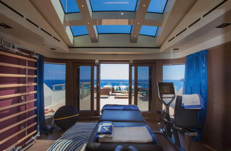 inside of a building with a large window and a table with chairs aboard SARAMOUR Yacht for Sale