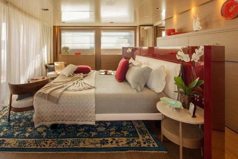 a bedroom with a bed and a table aboard SARAMOUR Yacht for Sale