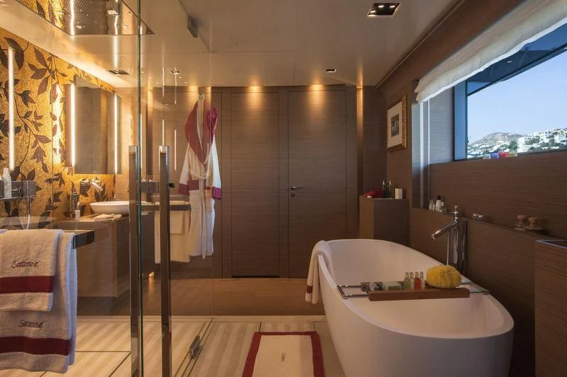 a bathroom with a tub and shower aboard SARAMOUR Yacht for Sale