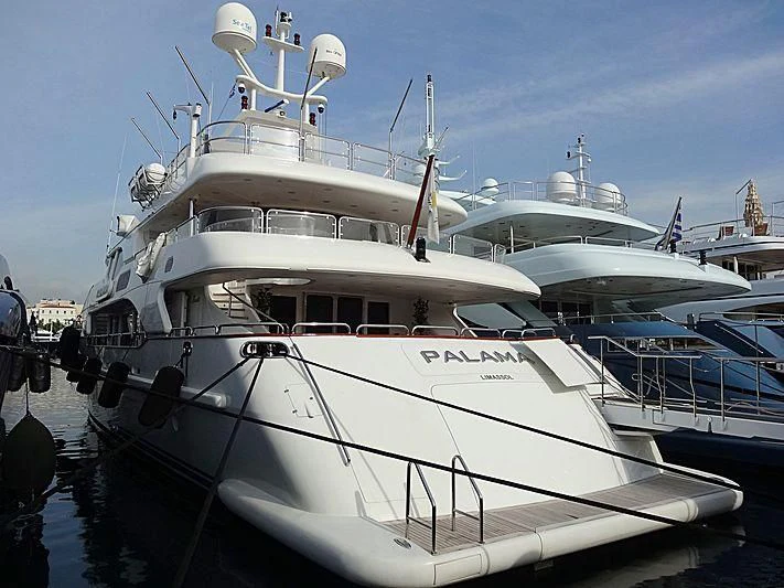 a large white boat in a harbor aboard PALAMA Yacht for Sale