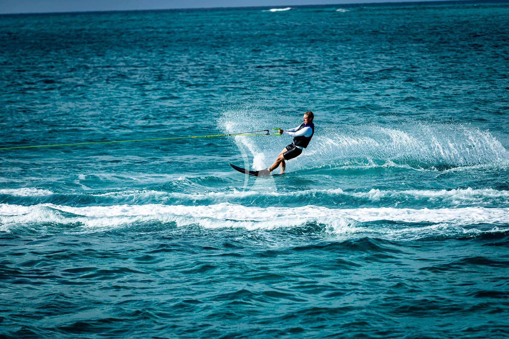 a man surfing on the waves aboard BOA VIDA Yacht for Sale