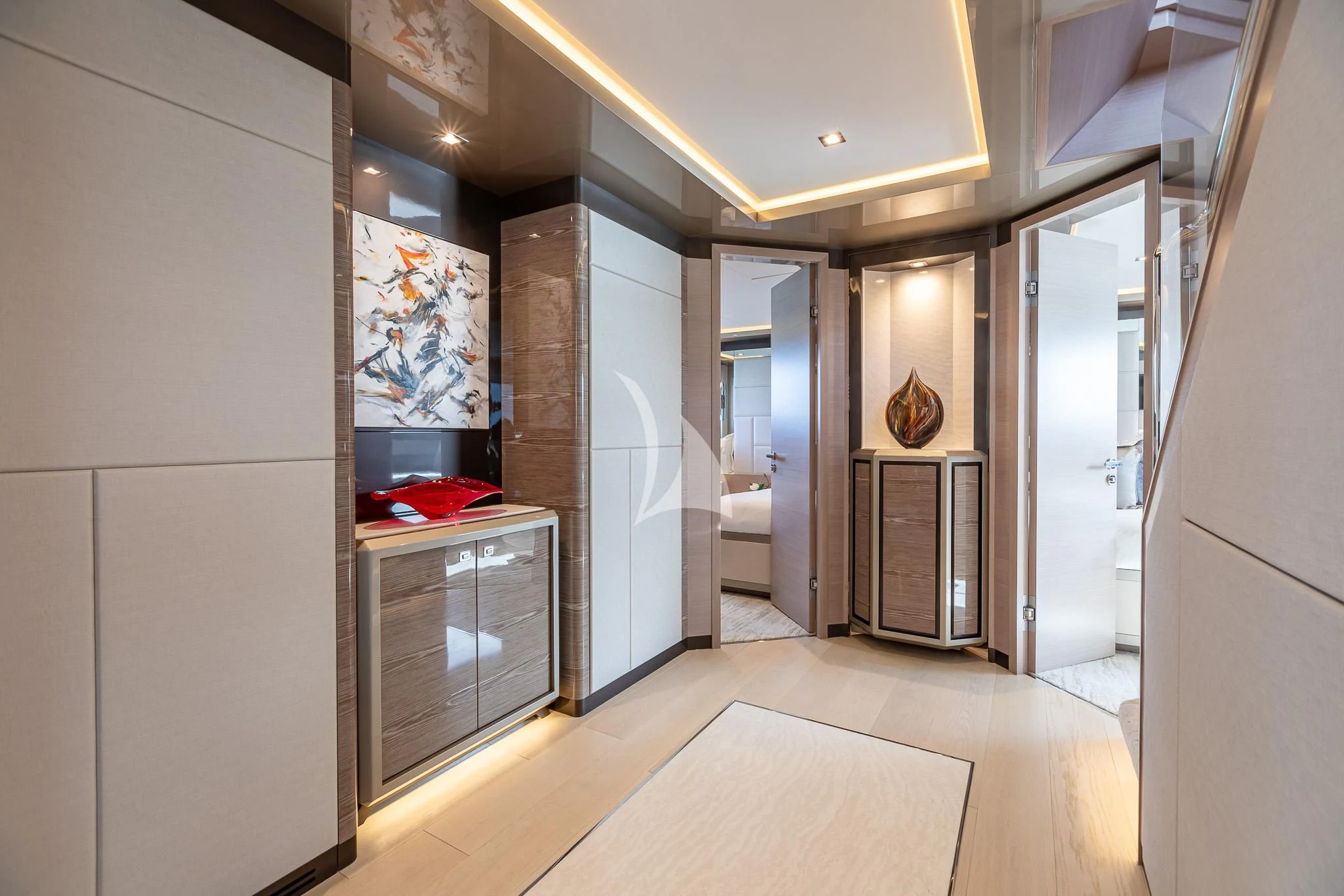 a room with a large mirror and a counter with a sink and cabinets aboard BOA VIDA Yacht for Sale