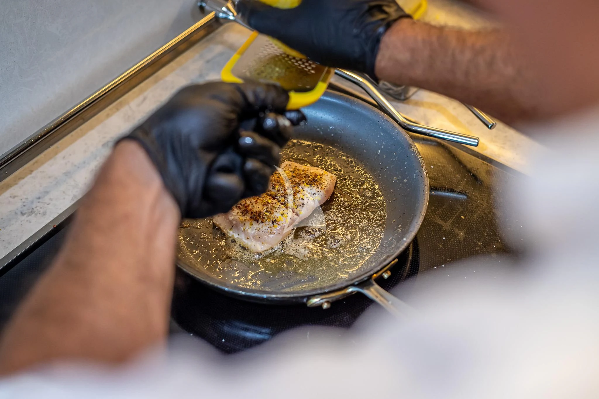 a person washing a fish aboard BOA VIDA Yacht for Sale