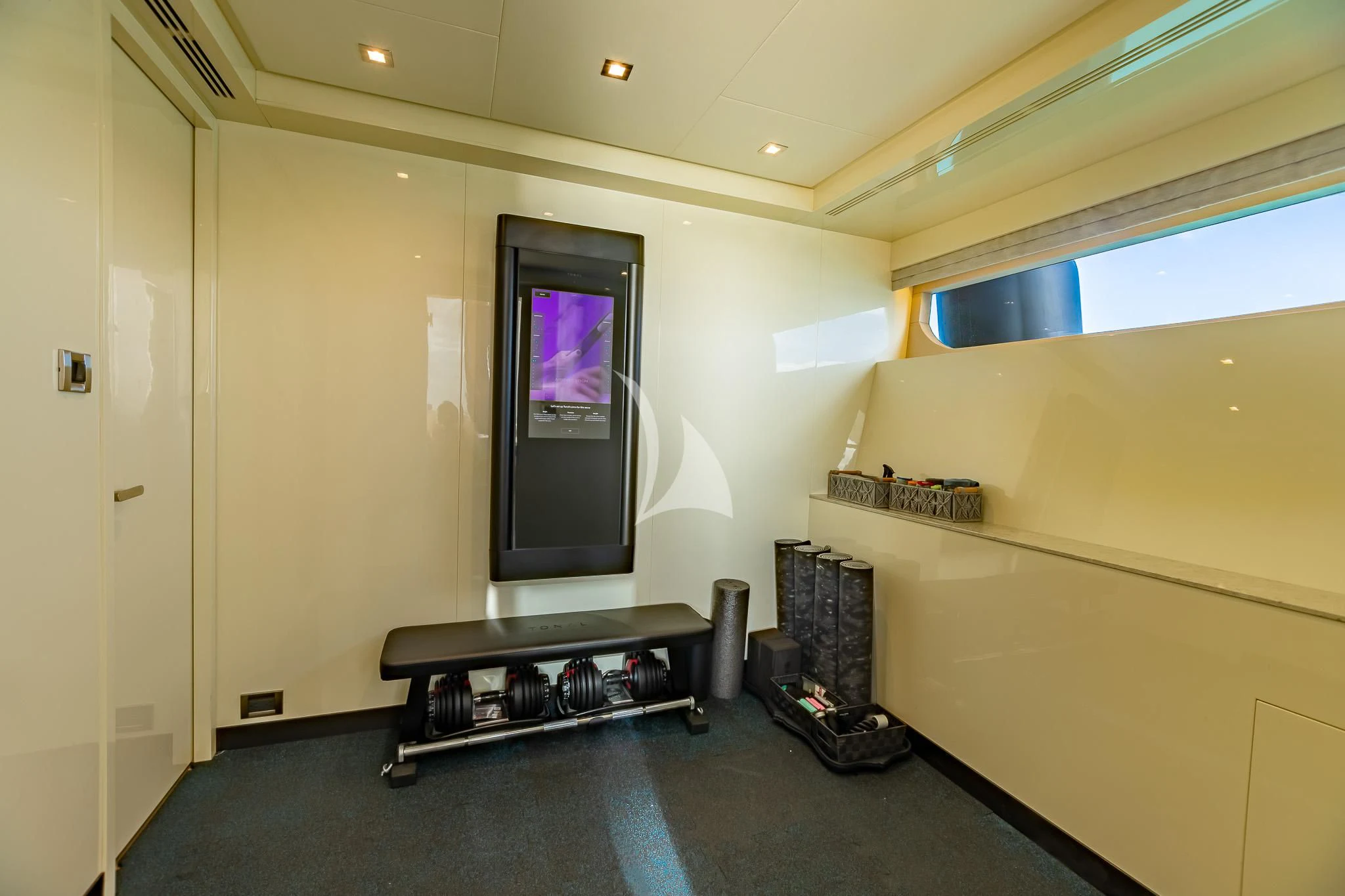 a room with a desk and a television aboard BOA VIDA Yacht for Sale