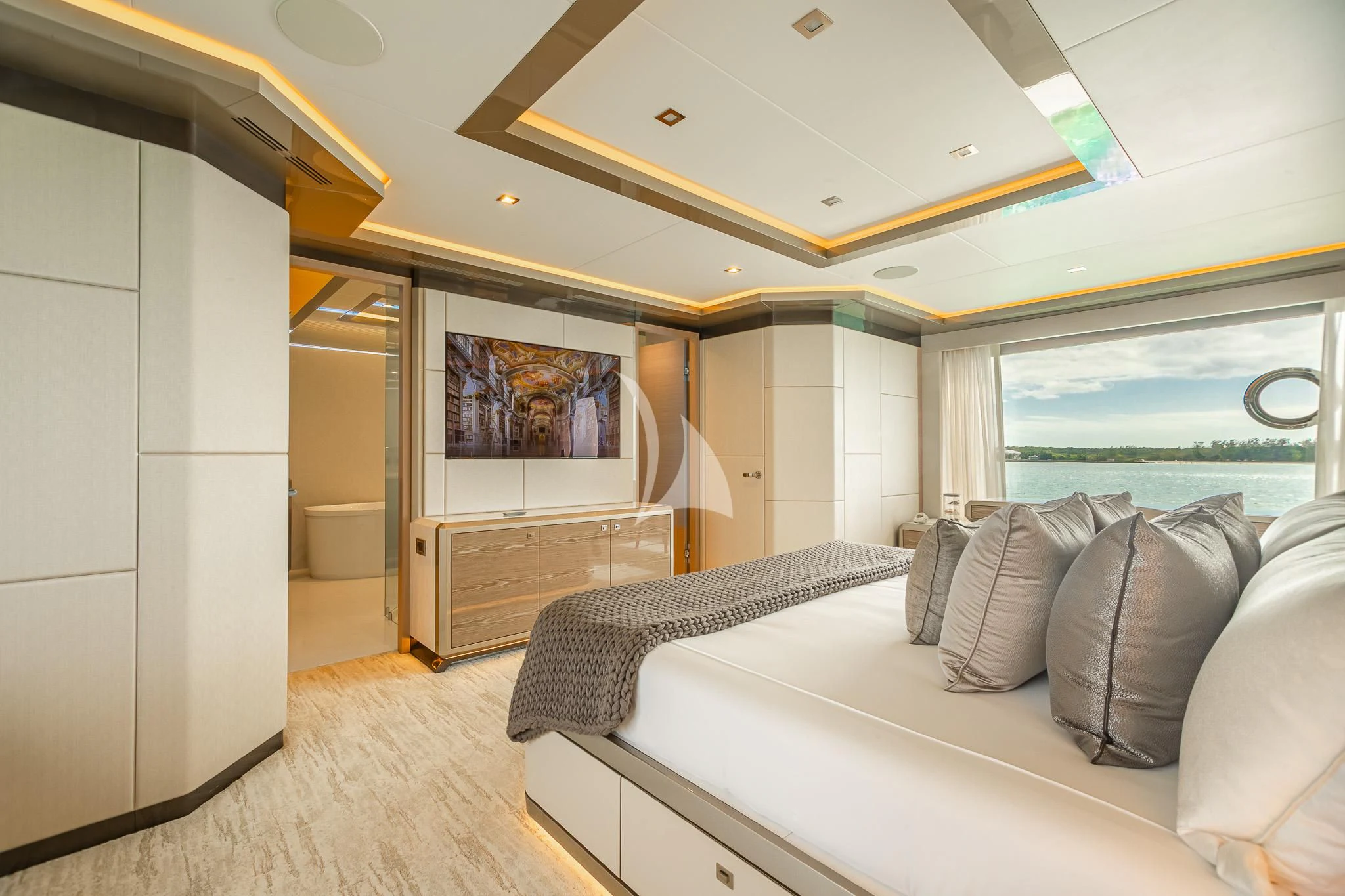 a bedroom with a bed and a large mirror aboard BOA VIDA Yacht for Sale