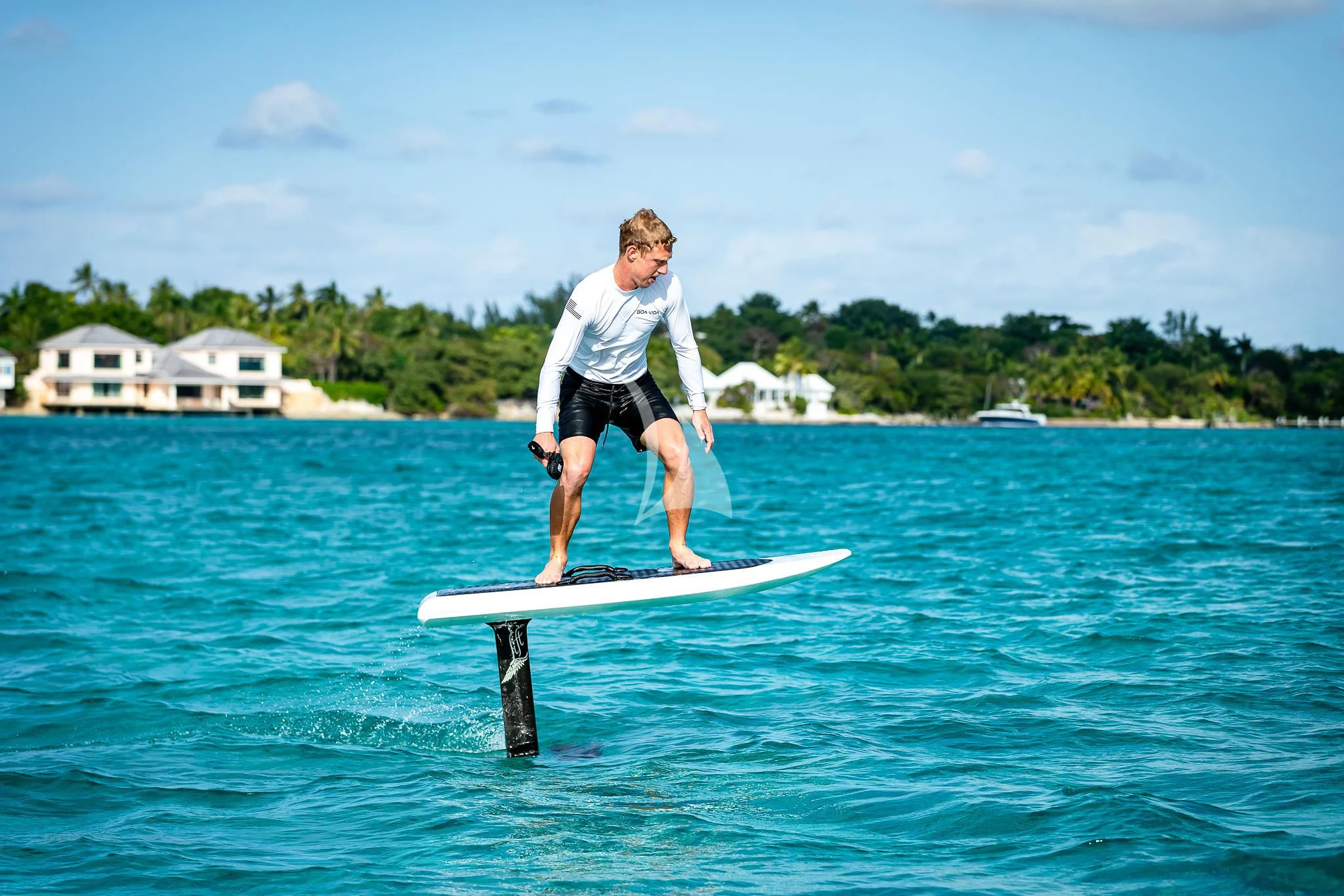 a man on a surfboard aboard BOA VIDA Yacht for Sale