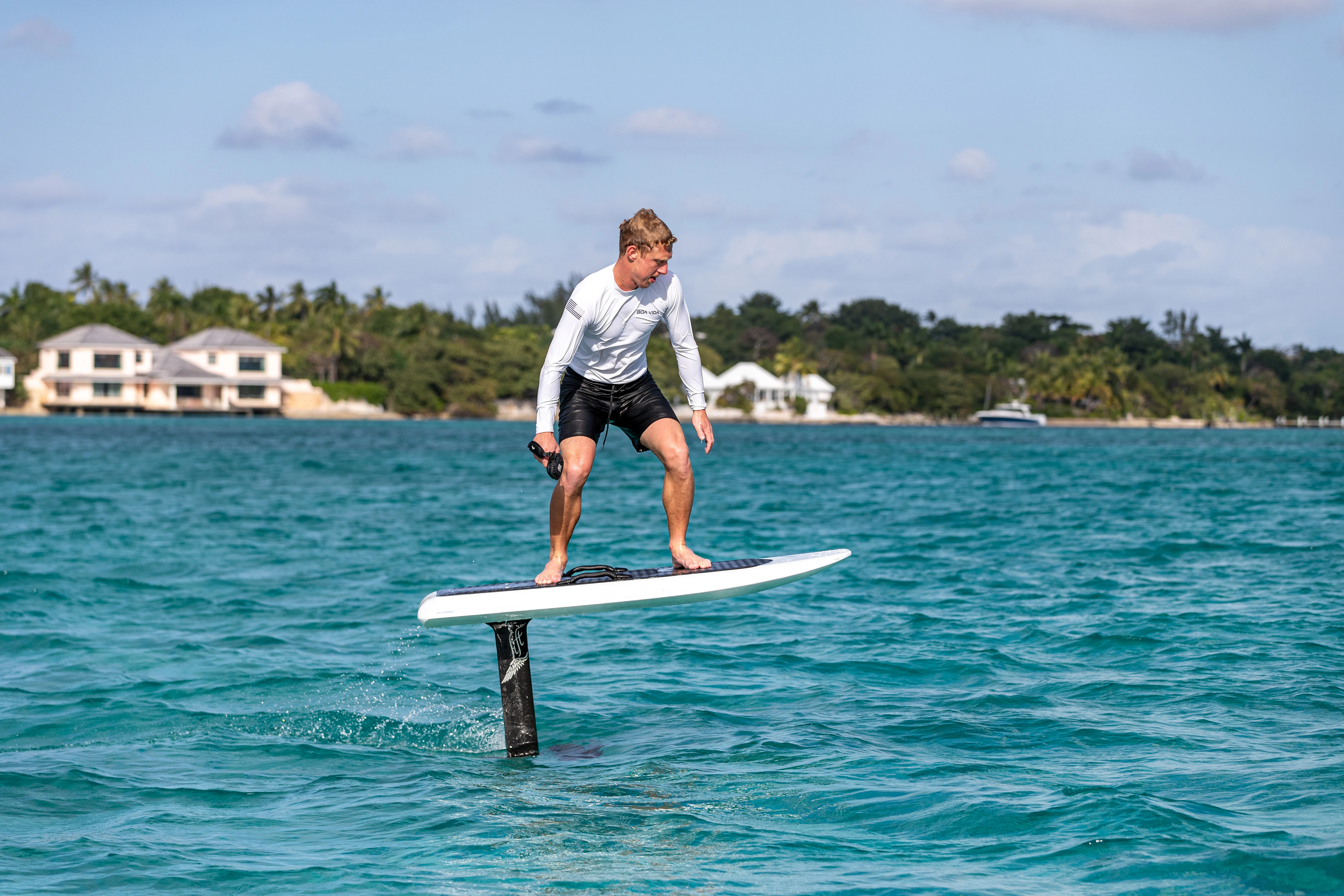 a man on a surfboard aboard BOA VIDA Yacht for Sale