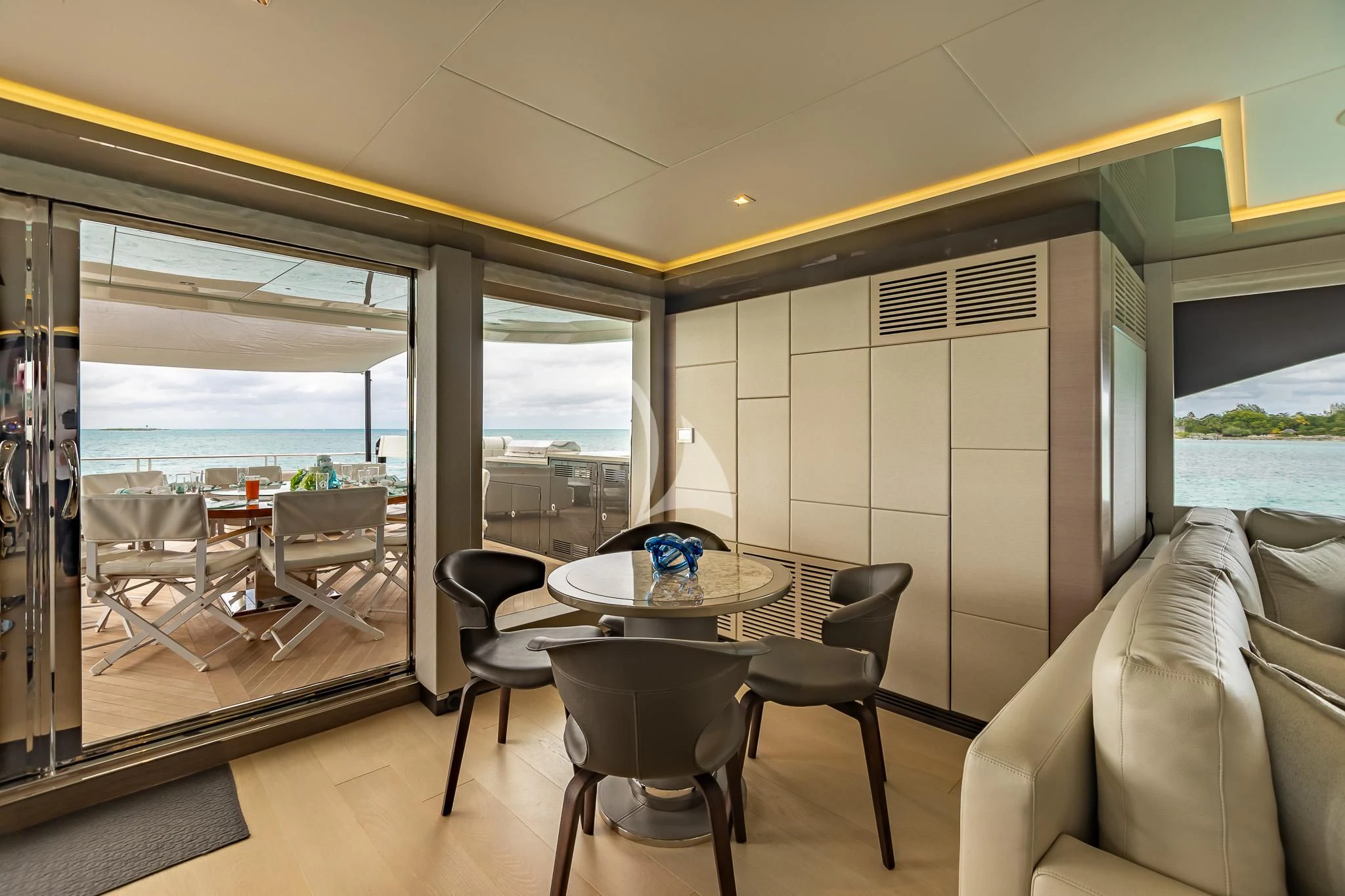a room with a table and chairs aboard BOA VIDA Yacht for Sale