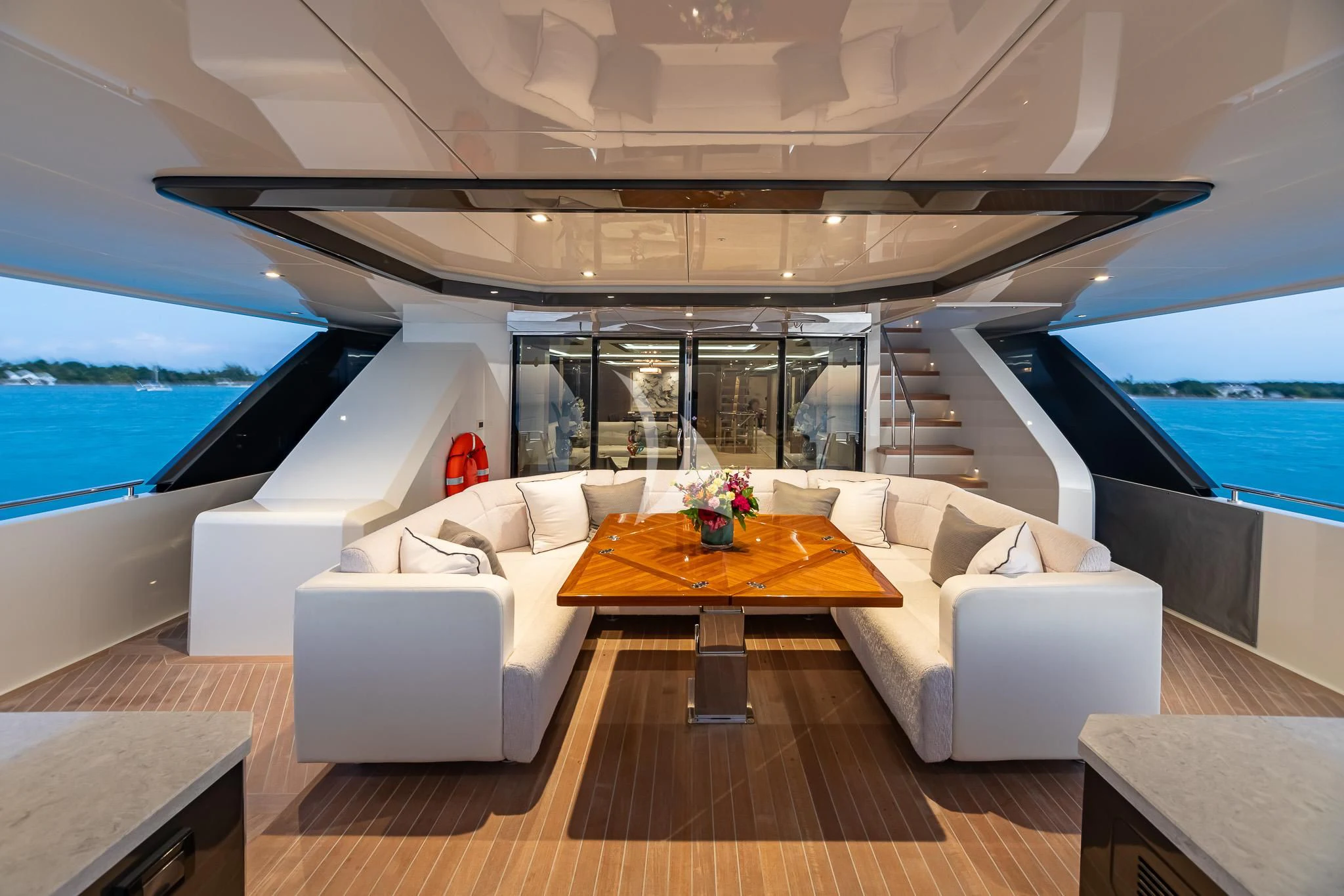 a living room with a large window overlooking the ocean aboard BOA VIDA Yacht for Sale