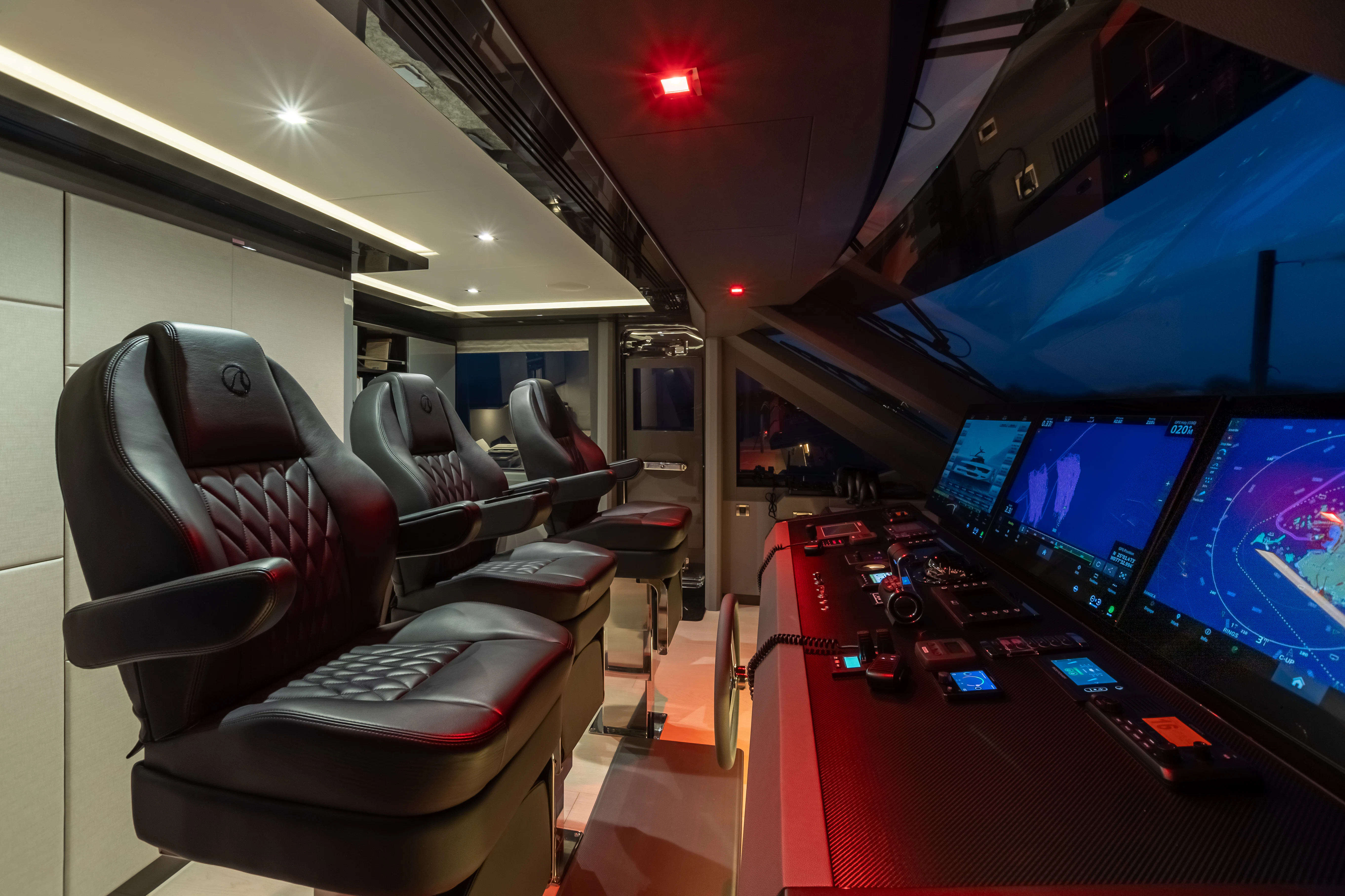 a room with a row of seats and a tv on the wall aboard BOA VIDA Yacht for Sale