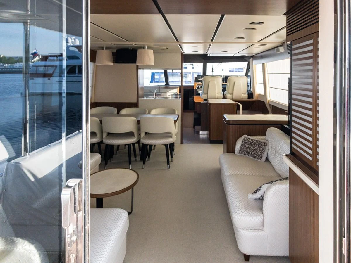 a room with a couch and a table and chairs aboard MAGELLANO 66 Yacht for Sale