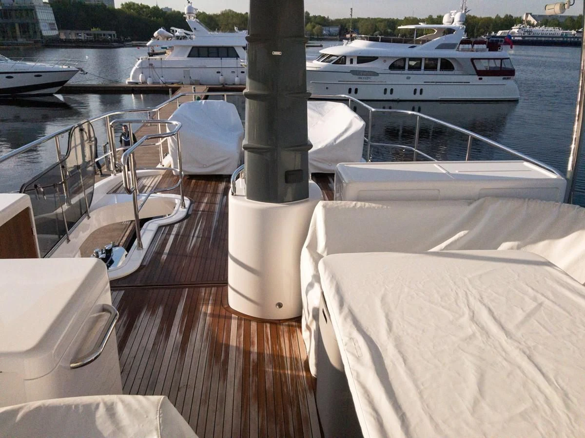 a table with chairs on it next to a body of water aboard MAGELLANO 66 Yacht for Sale