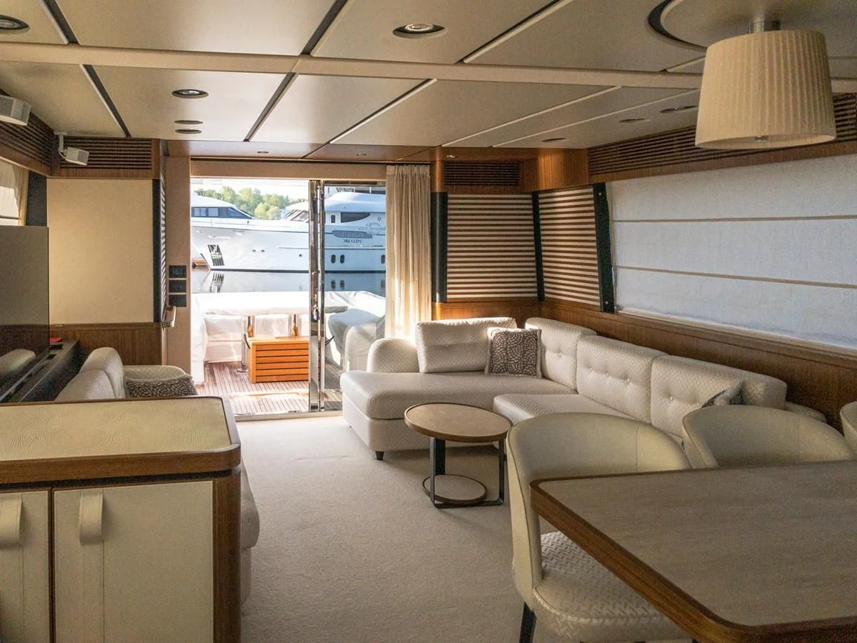 a living room with a couch and a table aboard MAGELLANO 66 Yacht for Sale