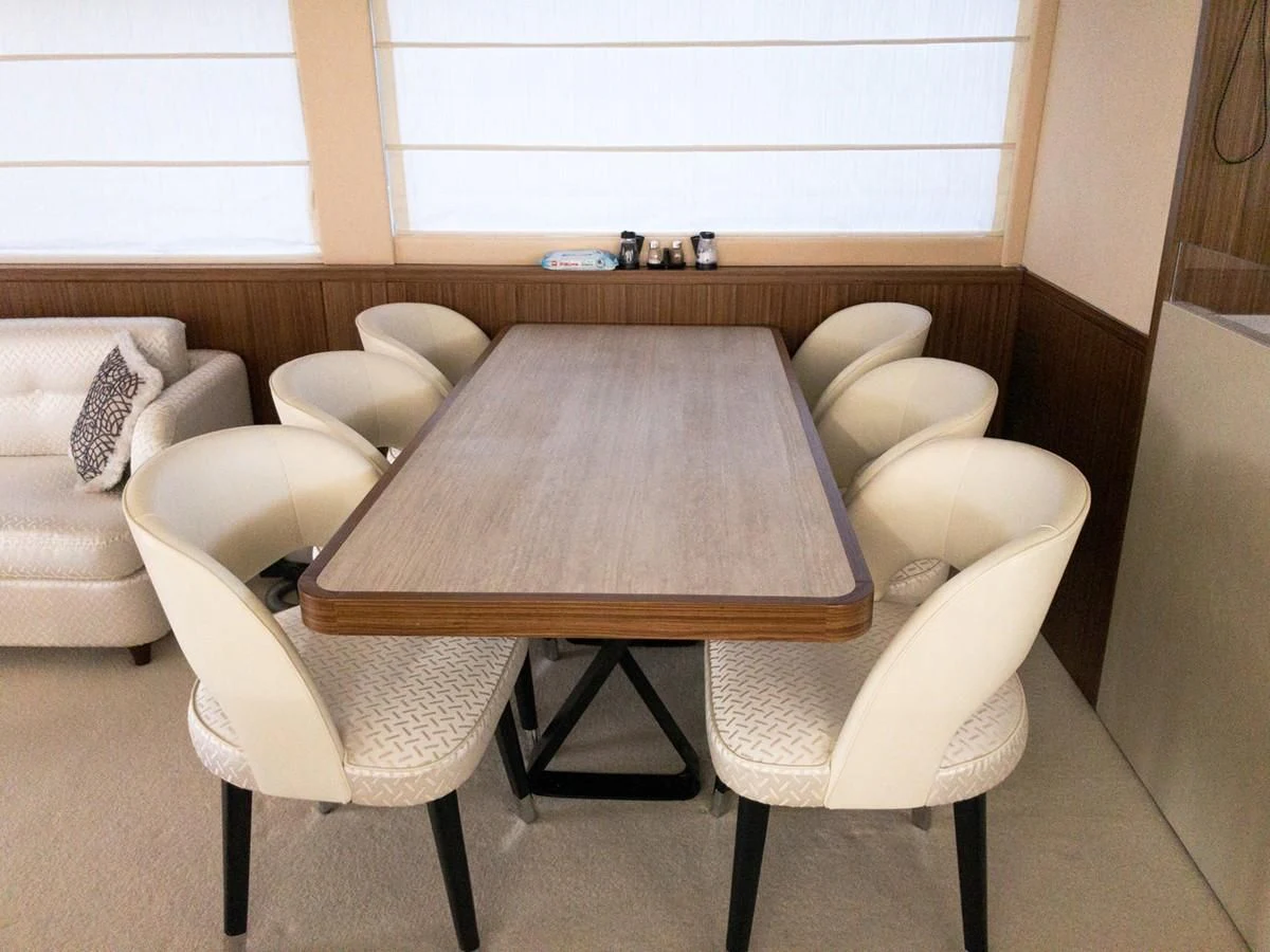 a table with chairs around it aboard MAGELLANO 66 Yacht for Sale