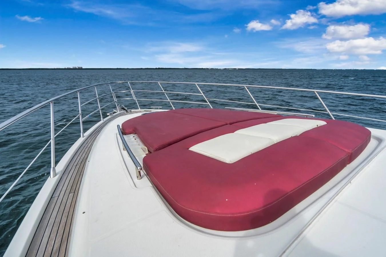 a red and white boat on a body of water aboard KNOTORIOUS IV Yacht for Sale