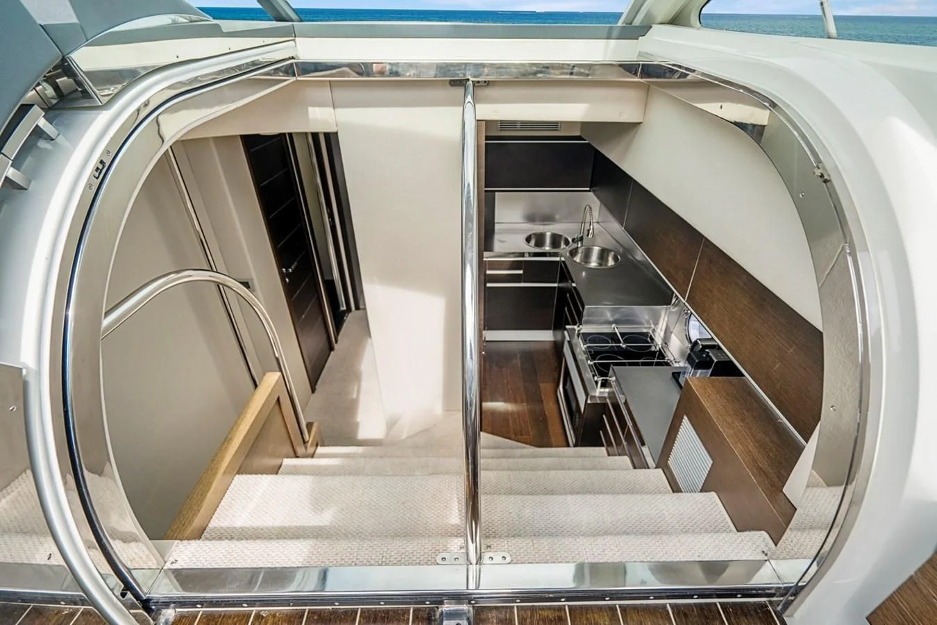 a staircase with glass doors aboard KNOTORIOUS IV Yacht for Sale