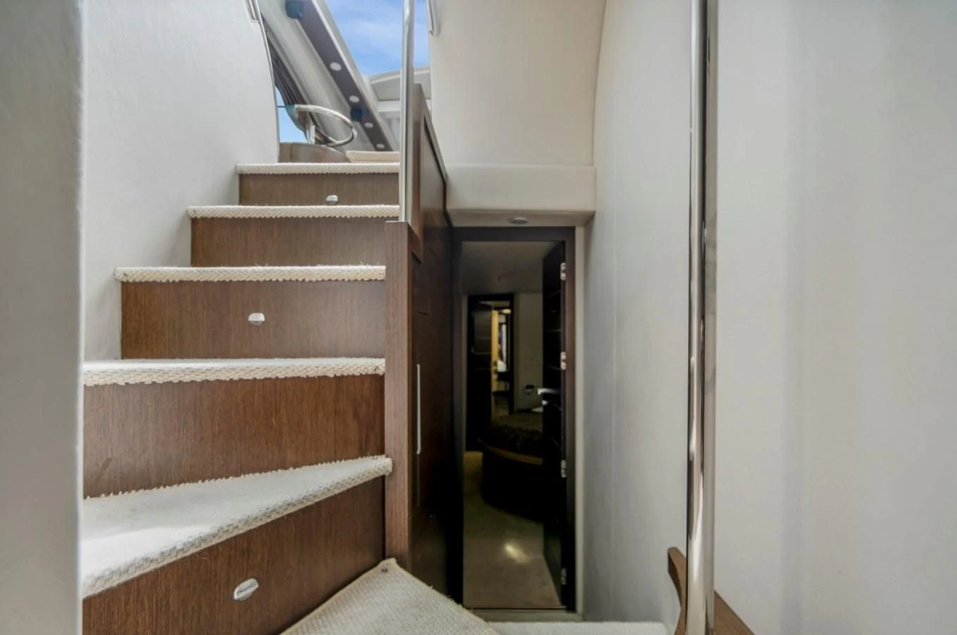 a staircase with wood railings aboard KNOTORIOUS IV Yacht for Sale