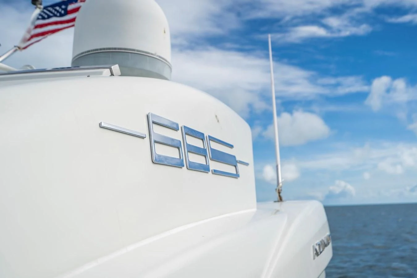 a boat with a flag on the front aboard KNOTORIOUS IV Yacht for Sale