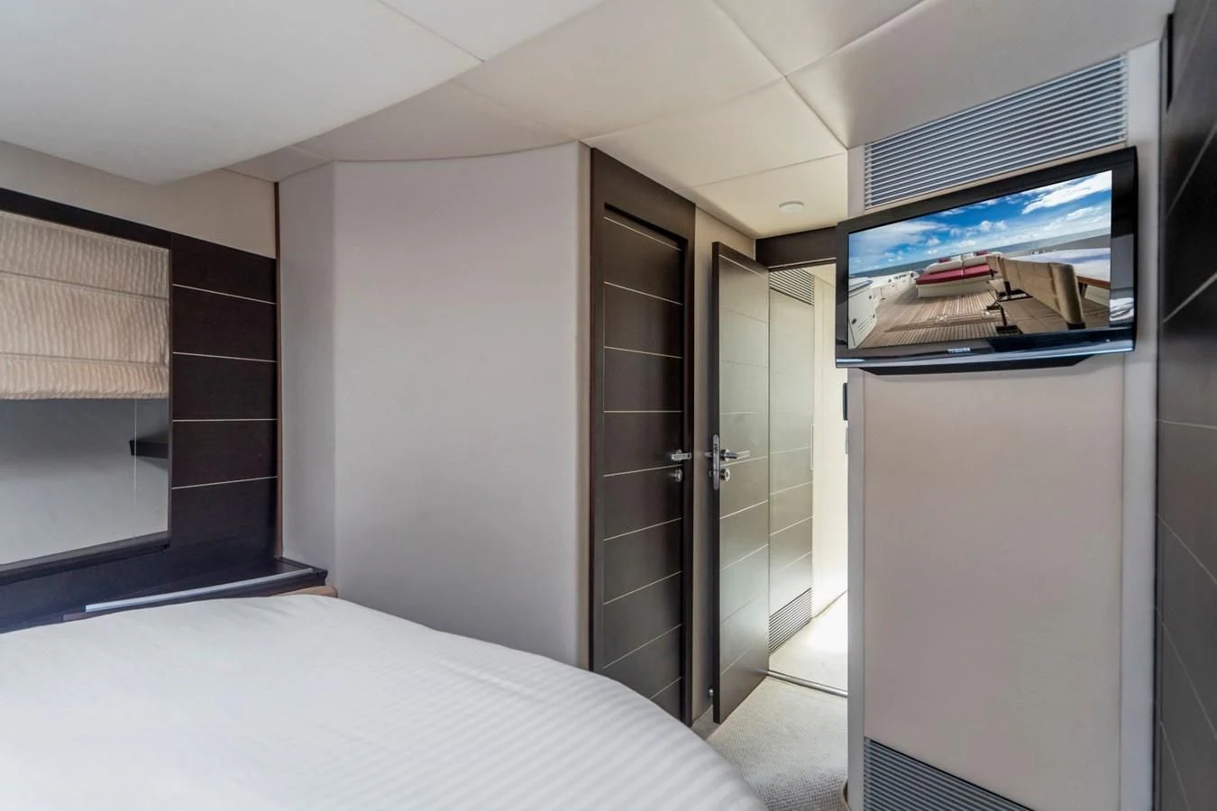 a room with a bed and a television aboard KNOTORIOUS IV Yacht for Sale