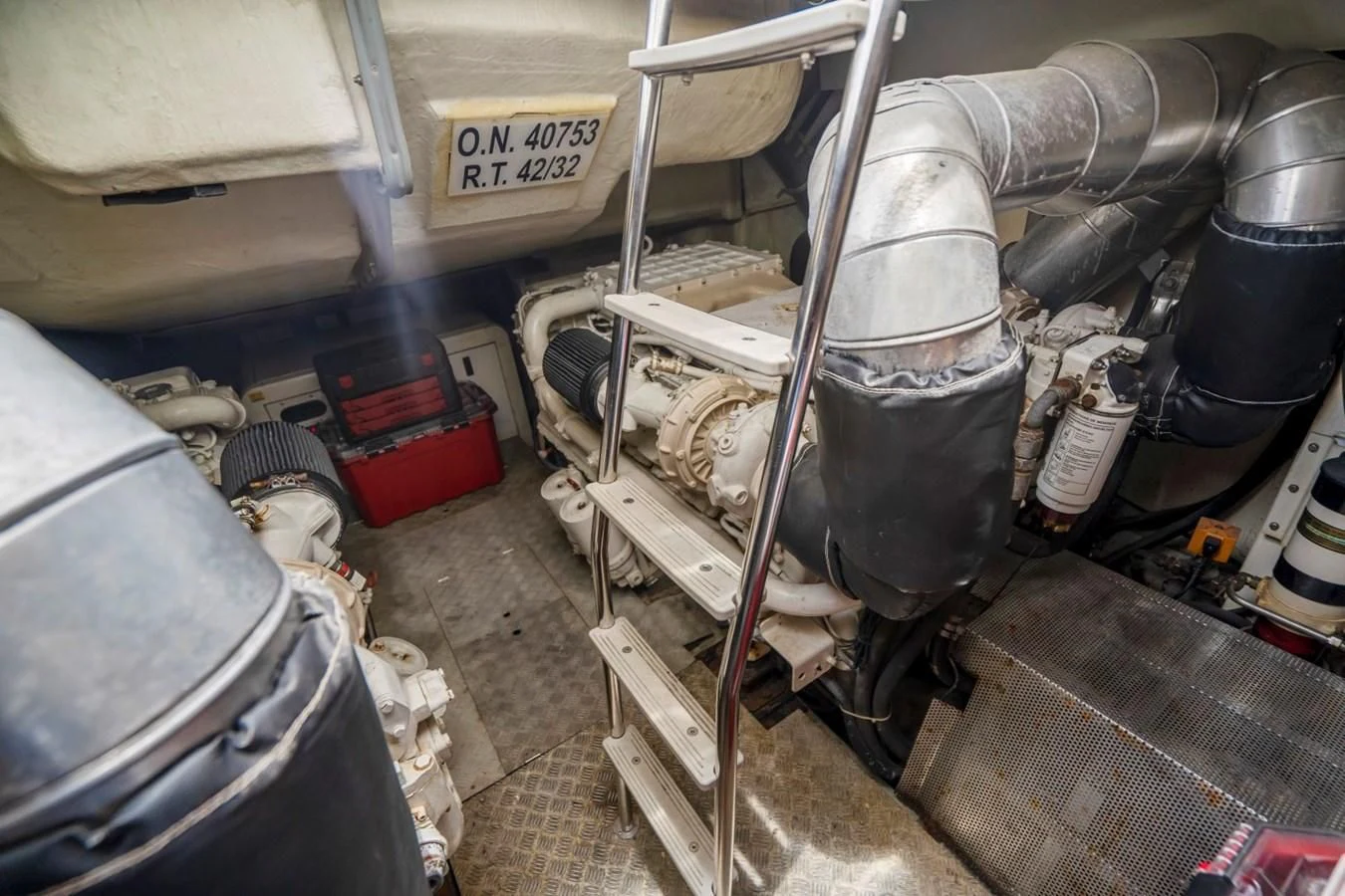 a car with a large stack of tires and a large stack of metal containers aboard KNOTORIOUS IV Yacht for Sale