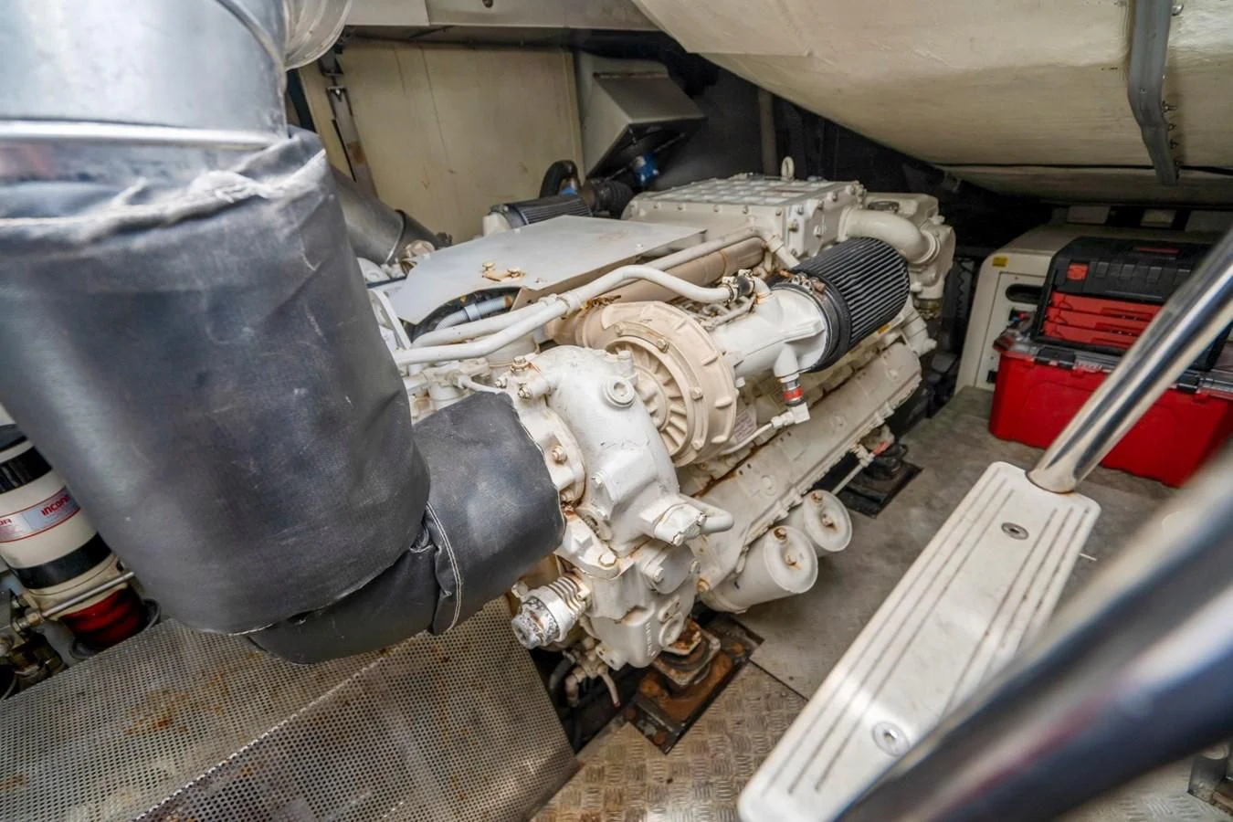 a car engine with a white pipe aboard KNOTORIOUS IV Yacht for Sale