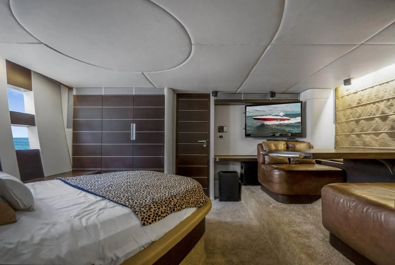 a bedroom with a bed and a television aboard KNOTORIOUS IV Yacht for Sale