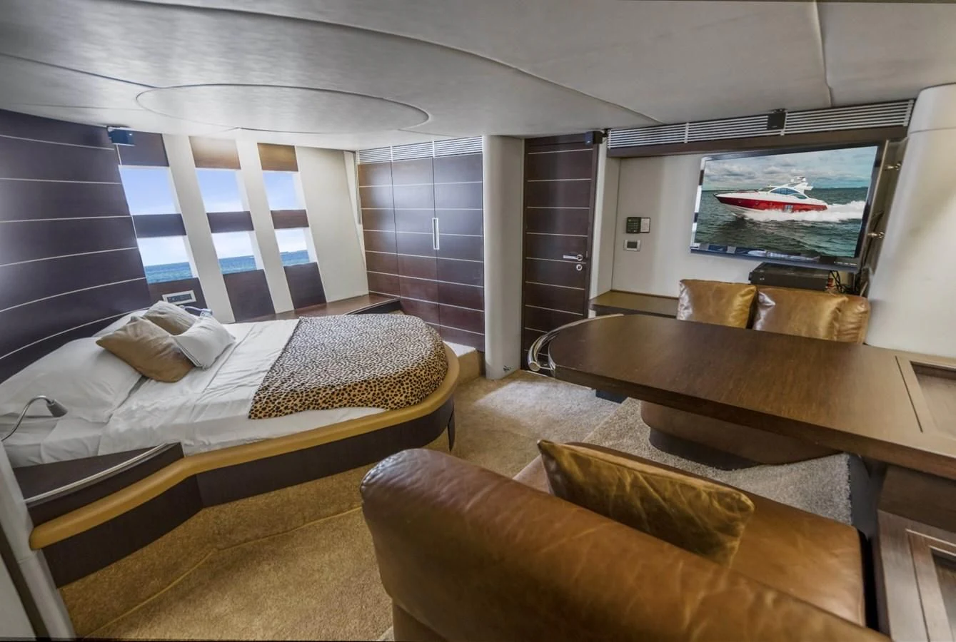 a room with a bed and a table aboard KNOTORIOUS IV Yacht for Sale
