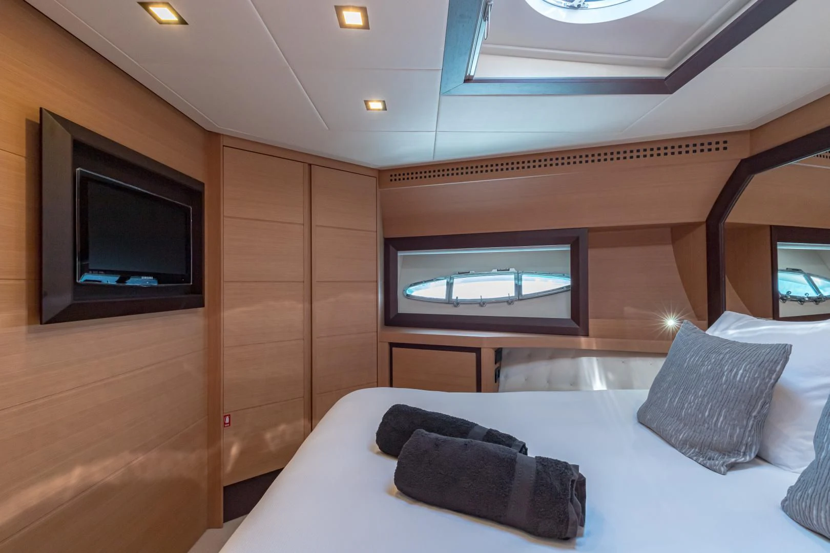 a room with a bed and a television aboard LOONEY Yacht for Sale