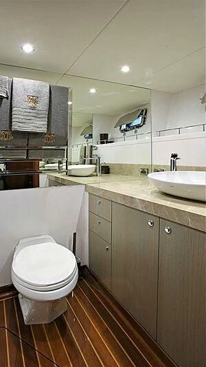 a bathroom with a toilet sink and a mirror aboard BELLE VIE Yacht for Sale