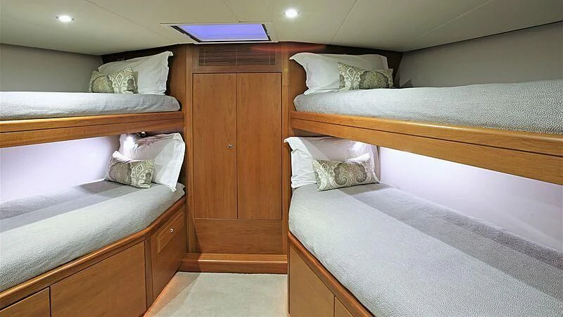 a room with a bed and a desk aboard BELLE VIE Yacht for Sale